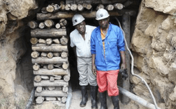 Miners standing in mine entrance