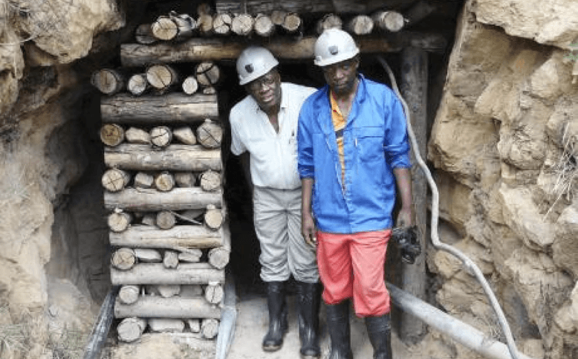 Miners standing in mine entrance